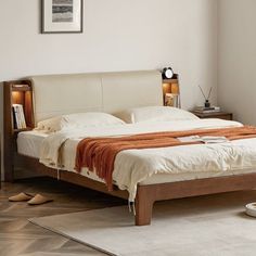 a bed sitting on top of a wooden floor next to a white carpeted floor