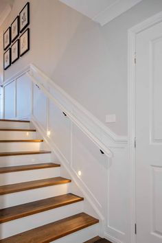 the stairs in this house have been painted white with wood treading and handrails