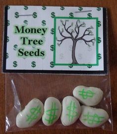 money tree seeds in plastic wrapper on wooden table next to card with dollar sign