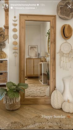 there is a mirror and some baskets on the wall in this room with white walls