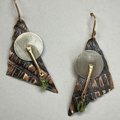 "Copper, Jewelers Bronze and Sterling silver metals, Peridot gemstone accent drop Jewelers Bronze Ear Wire  Size - 1 3/4\" x 7/8\" Lightweight earrings Contrasting metal colors and textures create a fun and artistic pair of earrings :)" Unique Soldered Drop Earrings, Unique Green Metal Earrings, Artisan Soldered Teardrop Earrings, Artisan Hammered Metal Earrings, Nickel-free Teardrop Fusion Earrings, Nickel Free Teardrop Fusion Earrings, Hammered Metal Fusion Jewelry, Fusion Hammered Metal Jewelry, Fusion Style Hammered Metal Jewelry