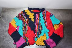 Reworked Textured Multi Sweater, size XL. ❤️DESCRIPTION: One of a kind, upcycled knit top.  Gorgeous and impactful in red, blue, teal, fuchsia and yellow.  A send up to classic Coogi style. Textured knit with an organic feel to the pattern.  Front, back, and sleeves feature textured designs.  Make it your own! ❤️MEASUREMENTS: * size XL * 44 inch bust * 22 inches long * 100% recycled lambs wool, cotton, acrylic ❤️SHIPPING: Immediate shipping worldwide; buy with confidence. ❤️MY SHOPS: Click this Red Patchwork Sweater, Red Knit Sweater With Patchwork, Red Patchwork Knit Sweater, Multicolor Knit Patchwork Tops, Multicolor Knit Winter Top, Fitted Knit Sweater With Patchwork, Retro Multicolor Knit Top, Fitted Multicolor Cotton Sweater, Multicolor Cotton Jacquard Knit Sweater