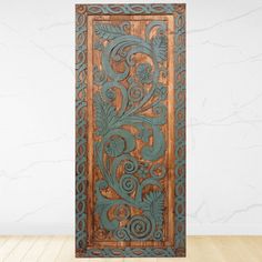 an intricately carved wooden door on a wood floor