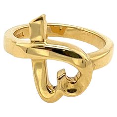 Elevate your jewelry collection with this exquisite Tiffany & Co Love Heart Ring by Paloma Picasso. Crafted in 18ct yellow gold, this stunning ring features a delicate love heart design that exudes elegance and romance. • Width of Band: 2.6mm • Width of Head: 15.3mm • Length of Heah: 14.8mm • Total Weight: 6.1g • Ring Size: K NS0072 Tiffany Love Ring Paloma, Love Heart Ring, Love Heart Design, Paloma Picasso, Tiffany And Co, Heart Design, Paloma, Tiffany & Co., Band Rings