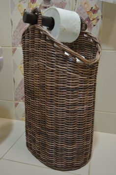 a wicker basket with a toilet paper roll in it