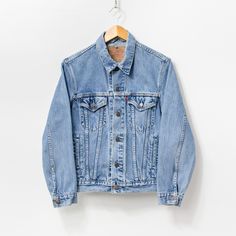 Vintage 90's Levi's denim jacket in classic stonewashed blue - 4 outer pockets - materials: 100% cotton denim SIZE: S MEASUREMENTS chest: 40 inches (102 cm) length: 24.5 inches (62 cm) sleeve length from the neck: 29.5 inches (75 cm) CONDITION - 8/10 - The jacket in great pre-owned vintage condition. Washed, ready to wear. Classic Denim Jacket With Pockets In Recycled Denim, Classic Medium Wash Denim Vest, Classic Light Wash Denim Jacket With Pockets, Light Wash Recycled Denim Jacket For Streetwear, Streetwear Washed Blue Recycled Denim Jacket, Medium Wash Recycled Denim Jacket For Streetwear, Classic Washed Blue Denim Jacket With Pockets, Streetwear Recycled Denim Jacket In Washed Blue, Blue Washed Denim Jacket From Recycled Material