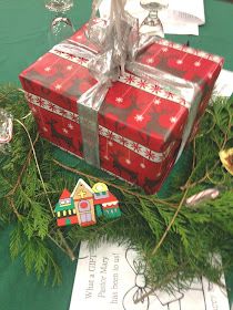 two wrapped presents sitting on top of a table next to christmas decorations and other items