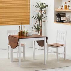 a kitchen table with two chairs next to it