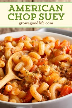 a white bowl filled with pasta and meat, topped with an american chop suey