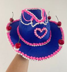 Handmade fake cake cowboy hat Can be used as a hat (delicate) or as an ornament  One size  Reworked from a dark blue felt cowboy hat  Message for custom decorations and designs Blue Brimmed Felt Hat For Festival, Blue Hat For Kentucky Derby Festival, Blue Hat For Kentucky Derby, Blue Felt Hat With Short Brim For Rodeo, Blue Hats For Rodeo And Kentucky Derby, Handmade Blue Hat Band For Rodeo, Handmade Blue Hat Bands For Rodeo, Western Style Blue Felt Hat For Kentucky Derby, Blue Country Style Festival Hat Band