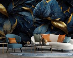 a living room with blue and gold leaves on the wall