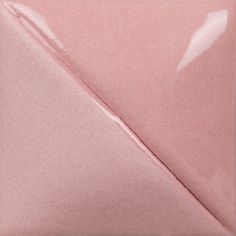 the corner of a pink ceramic tile with a diagonal triangle on it's side