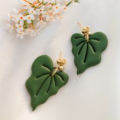 A stud / post for a person who loves plants and has a green apartment so that she can always have a piece of the jungle with her. The earrings are made of lightweight polymer clay. Metal elements are made of surgical steel, available in two colors (gold and silver). Surgical steel is a material that can be worn even by allergy sufferers. On request, I can make earrings in a different color and make a matching pendant. Length of the Earrings: 3,5 cm Earrings are handmade, so each piece may slightly differ. The delivery time for jewelry orders is about a week. Unique Leaf-shaped Earrings For Gift, Green Botanical Drop Earrings Jewelry, Handmade Tropical Green Jewelry, Green Leaf-shaped Earrings, Handmade Leaf-shaped Botanical Earrings, Botanical Green Drop Earrings, Handmade Botanical Leaf Earrings, Green Botanical Drop Earrings, Green Leaf-shaped Earrings For Gift