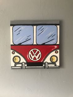 a red and white vw bus painted on a wall