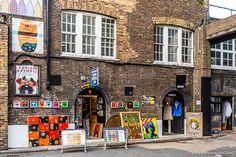 an old brick building with posters on it