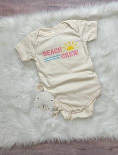 Time to head to the beach! Grab your beach crew and head out! This bodysuit is great for a beach vacation or everyday wear.  Taking a family trip? Grab one for the whole group. Comfy enough for your little one to play in all day!  All shirts are made to order and my current turn around time is about 2 weeks until your order will ship. Please keep this in mind when ordering. Casual Short Sleeve Summer Bodysuit, Summer White Short Sleeve Bodysuit, Playful Cotton Swimwear With Upf 50+, Cotton Swimwear For Summer Activities, Playful White Short Sleeve Swimwear, Playful Cotton Onesie For The Beach, Summer Vacation Cotton Onesie, Cute Short Sleeve Onesie For Summer, Summer Cotton Swimwear For Beach Party