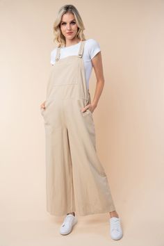 A Sleeveless Wide Leg Jumpsuit is a chic and versatile one-piece garment that features a sleeveless top with wide-leg pants. This style combines the comfort of a jumpsuit with the trendy silhouette of wide-leg pants, creating a stylish and effortless outfit option. The sleeveless design is perfect for warm weather or layering with a jacket or cardigan for cooler days. The wide-leg pants add a touch of sophistication and elegance to the overall look, making it a versatile piece that can be dresse Cute Jumpsuits For Women, Cream Jumpsuit Outfit, Stylish Jumpsuits For Women, Textiles Clothing, Jump Suits, Effortless Outfit, Cotton Jumpsuit, Clothing Designs, White Birch