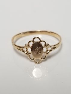 "Thanks for shopping our vintage estate store. We tend to sell well below wholesale and truly hope you enjoy all of our items. Many of the items are one of a kind, so please enjoy scrolling through the pictures and hopefully something will catch your eye. Brown spots are from camera or reflections. Estate 14k yellow gold monogram cursive capital M filigree ring. Custom made ring for our shop. Ring size: 4.5 Setting: 1/4\" to 3/8\" Band width: 1.4mm Weight: .73 gram Marked 14k and it's sweet. One Vintage Gold Initial Ring Stamped 14k, Classic Engraved Ring With Hallmarks, Vintage 14k Stamped Initial Ring As Gift, Vintage Gold Engraved Ring With Maker's Mark, Gold Engraved Ring With Maker's Mark As Gift, Gold Engraved Ring With Maker's Mark For Gift, Vintage Yellow Gold Signet Ring With Hallmarks, Vintage Yellow Gold Signet Ring With Maker's Mark, Victorian Gold Initial Ring As Gift