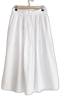 Elegant Cotton Skirt With Elastic Waistband, Cotton Long Skirt For Daywear, Classic Cotton Bottoms With Voluminous Skirt, White Cotton Skirt With Pleated Waist, Classic Voluminous Skirt With Pleated Hem, White Long Skirt With Pleated Waist, Classic Skirt With Pleated Waist And Voluminous Fit, White Cotton Bottoms With Pleated Hem, Voluminous Skirt With Pleated Waist For Daywear