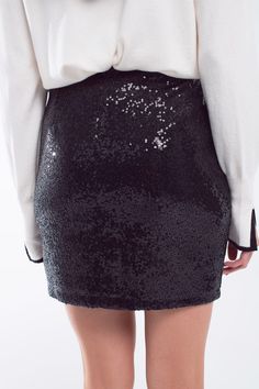 Introducing our Mini Bodycon Skirt in Black Small Sequins – a super fashionable piece that adds a touch of glamour to your wardrobe. This mini skirt features a bodycon fit, accentuating your curves and creating a chic and elegant style. The super small sequins add a subtle yet eye-catching texture, making it perfect for various fashionable events.  The mini length of the skirt makes it versatile, allowing you to pair it with one of our matching sequin tops for a coordinated look or with a blouse for a sophisticated ensemble.  Crafted from a blend of 95% polyester and 5% elastane, this skirt offers both comfort and flexibility. The zip fastening ensures easy wear, and the high waist rise adds a modern touch to the overall silhouette.  The model is wearing size S, and with measurements of 33 Classic Blouses, Bodycon Skirt, Style Party, Style Upgrade, Sequin Mini, Knitwear Tops, Black Mini Skirt, Body Con Skirt, Sequin Top