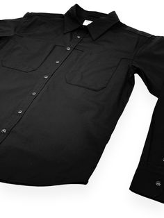 The Dress Shirt in Black from Machus Private Label. Our modern interpretation of a wardrobe staple. DetailsHidden pockets on the chest create a nice lateral seam that continues around the back of the shirt.Subtle bar embroidery on the back left hemSubtle scalloped hem for leaving untucked or tuckedBlack pearlesque metal buttons97% Cotton3% Stretch for incredibly easy wear WASH COLD AND HANG DRY Measurements Tag Size Shoulder Chest Length Sleeve Small 17.5" 21.5" 27.5" 24" Medium 18.5" 23" 28" 24.5" Large 19" 24" 30" 25.5" X-Large 21" 25" 30" 27" XXL 22.5" 25.5" 31.5" 28" Please Note – The Shoulder Measurements are taken from shoulder seam to shoulder seam. Chest Measurements are taken from underarm to underarm. Length is measured from the top of the shoulder seam to the bottom of the hem. Black Collared Dress Shirt With Button Closure, Black Button-up Shirt With Flap Pockets, Black Button-up Outerwear With Snap Buttons, Black Button-up Blouse With Back Button Closure, Black Button-up Shirt With Back Button Closure, Blue Flats, Private Label, Mens Button Up, Scalloped Hem