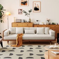 a living room with white couches and black and white rugs on the floor