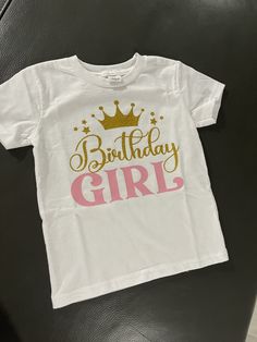 This beautiful t shirt is made to order. This  T shirt is made with a beautiful gold glitter and a soft pink vinyl. Gold Short Sleeve Top With Glitter Print, Gold Short Sleeve Tops With Glitter Print, Pink Birthday T-shirt With Name Print, Pink T-shirt With Name Print For Birthday, Pink T-shirt For Birthday, Pink Glitter Print Top For Birthday, Pink Glitter Print Short Sleeve T-shirt, Personalized Graphic Tee For Birthday, Gold Letter Print T-shirt For Birthday