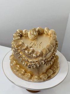 a cake with gold icing on a white plate