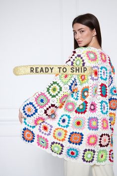 a woman is holding a crocheted shawl with the words ready to ship written on it