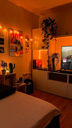 a bed room with a neatly made bed and a flat screen tv on the wall