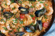 a skillet filled with seafood and rice