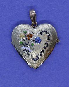 This hand-made heart locket is as sentimental and unique as it gets. It is made of 14 karat gold. It is both beautiful and functional. The beautiful enamel bouquet of forget-me-not flowers with a bow makes it a perfect Valentine's present. It uniquely holds 4 photos which insert into the top of the locket's 3 frames. The entire locket is handmade, from it's precision hinge to the handmade clasp. It is hard to match the workmanship of this locket and it's engraving. It is truly heirloom quality. Enamel Locket Jewelry For Anniversary, Heirloom Black Enamel Jewelry As Gift, Heirloom Black Enamel Jewelry For Gift, Vintage Heart-shaped Enamel Jewelry, Heirloom Enamel Jewelry Gift, Vintage Enamel Keepsake Jewelry, Nyc Jewelry, Valentines Presents, Round Locket