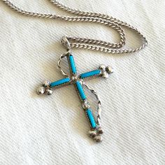 Vintage Turquoise Cross Necklace Southwestern 18 Inch Sterling Silver Western Jewelry Made from sterling silver and turquoise, this necklace makes a sweet southwestern statement. The cross measures 1 3/16" (3 cm) long. It is unmarked but is guaranteed to be sterling silver. It hangs from an 18 inch long 1 mm thick sterling silver cable chain that is marked 925 near the spring ring. The cross and chain weigh 3.25 grams combined. They are in excellent vintage condition and ready to wear. Is it a gift? Need to buy a card? All cards ship free with purchase. http://www.etsy.com/shop/AdobeHouseVintage?section_id=13802190 Thanks so much for looking! Cross Necklace Vintage, Turquoise Cross Necklace, Turquoise Cross, Western Jewelry, Vintage Turquoise, Necklace Vintage, Cable Chain, Spring Rings, Vintage Necklace