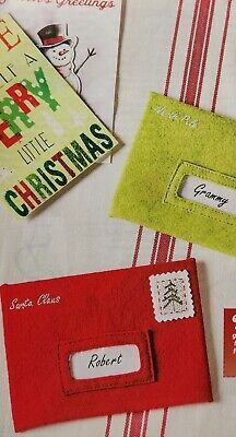 some christmas cards and envelopes on a table