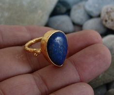 METAL: 925k Silver GEM: lapis COATING: 24k gold over (We can made a special type of coating for your personal preference ) MATERIEL : 925K Sterling Silver ( Some of my items vermeil gold over silver for looks rich . But i can finish in silver too ) PAYMENT : We accept paypal payment RING SIZE: 7 (your desired size is made) SHIPPING PRICE AND DURATION: We are shipping worlwide. Your products are sent within 2 business days after the order. 1-3 working days to Europe United States 6-10 working day Gold Sapphire Ring In Sterling Silver, Anniversary Yellow Gold Lapis Lazuli Rings, Gold Sterling Silver Sapphire Ring With Polished Finish, Gold Sapphire Ring With Polished Finish In Sterling Silver, Gold Sapphire Ring With Polished Sterling Silver, Unique Gold Sapphire Ring In Sterling Silver, Gold Rings With Lapis Lazuli Gemstone, Fine Jewelry Lapis Lazuli Rings For Gifts, Gold Lapis Lazuli Gemstone Rings