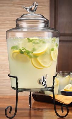 a glass pitcher filled with lemonade and ice