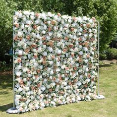 an artificial flower wall is shown in the grass