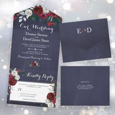 wedding stationery with flowers and snowflakes in the background, including an envelope