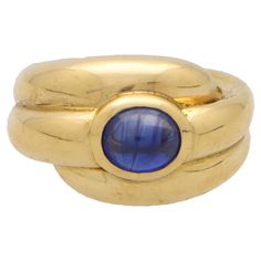 A beautiful vintage French sapphire bombé ring set in 18k yellow gold. The ring is designed in a raised fluted bombé design and is centrally set with a rub over set oval cabochon sapphire. Due to the design, this piece stands out beautifully on the finger. The piece could be worn for a variety of occasions and easily paired with other jewellery colours and styles. The ring is currently a UK finger size L ½ (USA size 6), this can be resized for a perfect fit upon request. The ring is stamped with Formal Gold Oval Cabochon Sapphire Ring, Gold Oval Cabochon Sapphire Ring For Formal Occasions, Formal Gold Sapphire Ring With Oval Cabochon, Gold Sapphire Ring With Oval Cabochon For Formal Events, Classic Yellow Gold Sapphire Ring Oval Cabochon, Formal Yellow Gold Cabochon Sapphire Ring, Formal Domed Cabochon Sapphire Ring, Classic Yellow Gold Sapphire Ring With Cabochon, Classic Domed Sapphire Ring With Polished Finish