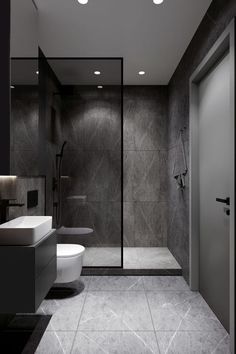 a bathroom with a toilet, sink and shower stall in it's own space