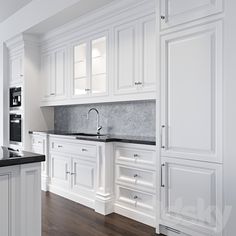 an all white kitchen with marble counter tops and wooden flooring is pictured in this image