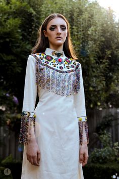 Tabora Beaded Fringe Dress: African embroidered rainbow Bead Fringe Dress, Hmong Beading, White Bohemian Embroidered Dress For Festive Season, Fitted Multicolor Dress With Tassels, Fitted Multicolor Dresses With Tassels, White Embroidered Festive Dress For Festivals, White Embroidered Festive Dress, Festive White Embroidered Dress For Festivals, Bohemian Multicolor Fringe Dress