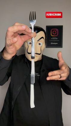 a man wearing a mask holding a fork and knife to his face with an instagram sticker on it