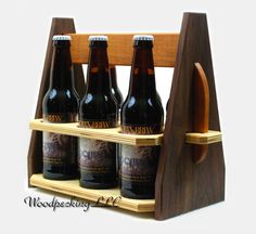 six beer bottles are in a wooden holder