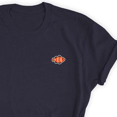 Fish Clownfish Shirt, Clownfish Lover T-shirt, Fish Lover Shirt, Ocean Lover Simple T-shirt, Clownfish Lover Gift, Fish Unisex T-Shirt, Fish Take this one by your side everywhere. Friends will love it! This t-shirt feels soft and lightweight, with the right amount of stretch. It's comfortable and flattering for both men and women. * 100% cotton (heather colors contain polyester) * Fabric weight: 5 oz * Shoulder-to-shoulder taping * Side-seamed Time for Delivery: * Processing & production tim Graphic Tee T-shirt With Fish Print, Graphic Tee With Fish Print And Crew Neck, Graphic Fish Print T-shirt With Short Sleeves, Fish Print Crew Neck Graphic Tee, Graphic Fish Print Short Sleeve T-shirt, Graphic Tee With Fish Print Short Sleeve, Cotton Short Sleeve T-shirt With Fish Print, Blue Short Sleeve Top With Fish Print, Casual Crew Neck T-shirt With Fish Print