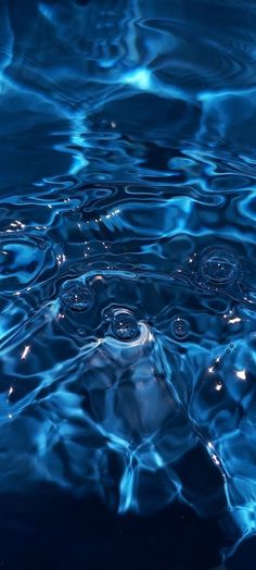 blue water with ripples and bubbles in it