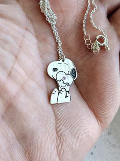 The necklace is a beautiful gift for any occasion to surprise your loved one. Made of high-quality materials and with an embedded spirit, it is a fun and gentle gift for anyone who likes Snoopy's little character. A text or an important date can be written on the back of the figurine. necklace length: 45 cm /  17.72 inches. pendant height: 22mm / 0.87inch. pendant width: 15mm / 0.59inch.  material: silver sample 925 Cute Silver Sterling Silver Charm Necklaces, Cute Nickel-free Pendant Jewelry, Cute Nickel-free Sterling Silver Necklaces, Cute Silver Charm Necklaces, Cute Sterling Silver Pendant Charm Necklaces, Cute Sterling Silver Pendant Charm Necklace, Cute Nickel-free Silver Charm Necklace, Cute Silver Nickel-free Charm Necklaces, Cute Silver Nickel-free Charm Necklace