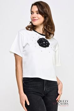 Elevate your everyday style with our stunning La Vie En Rose Embellished Top! Effortlessly chic and refreshingly unique, this white top boasts a black rose intricately embellished with shimmering rhinestones and pearls throughout. It's the perfect fusion of simplicity and sophistication, adding a touch of floral elegance to your wardrobe. This tee is a fashion essential that effortlessly transitions from day to night. Pair it with your favorite denim for a casual yet chic look during the day, or Glamorous White Embellished Tops, Elegant Pearl Embellished Tops For Spring, Hair Accessories Gift, Embellished Top, Fashion Essentials, Black Rose, Everyday Style, Fall Dresses, White Top