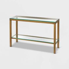 a glass and wood console table with two shelves on one side, against a white background