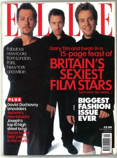 a magazine with two men on the cover and one man in black standing next to each other